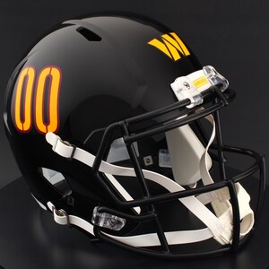 May include: A black football helmet with a black facemask, white chin strap, and the number "00" in orange with a yellow outline on the side. The team logo is yellow. The helmet is glossy.