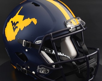 May include: A navy blue football helmet with a yellow stripe and a yellow outline of West Virginia. The helmet has a dark face mask and clear eye shields. The Riddell logo is visible on the helmet.