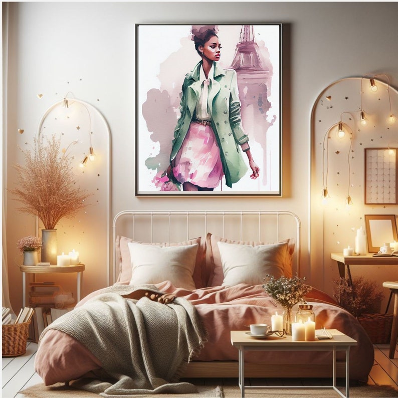 May include: A watercolor painting of a woman in a green coat and pink skirt standing in front of the Eiffel Tower. The painting is framed and hanging on a wall in a bedroom.