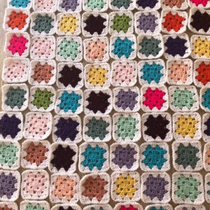 May include: A set of three ceramic mugs with a speckled, matte finish. The mugs are in shades of cream, light gray, and dark gray. Each mug has a simple, minimalist design and a rounded handle.