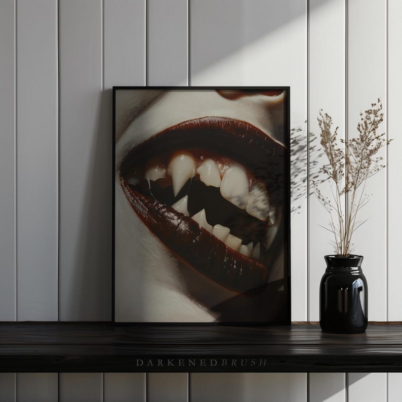 May include: A close-up of a person's mouth with dark red lipstick and sharp, white fangs. The image is in black and white with a high contrast.