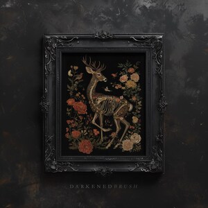 May include: A framed illustration of a deer skeleton with antlers, surrounded by flowers and birds. The background is black, and the frame is black with ornate details. The text "DARKENED BRUSH" is printed below the frame.
