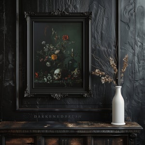 May include: An oil painting in a black frame depicting a still life with flowers, a skull, and a bottle. The painting is hanging on a dark wood wall with a white vase containing dried flowers on a black table.