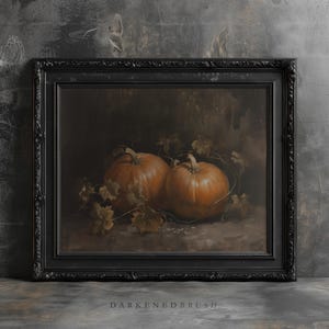 May include: A painting of two orange pumpkins with green leaves in a dark brown frame.