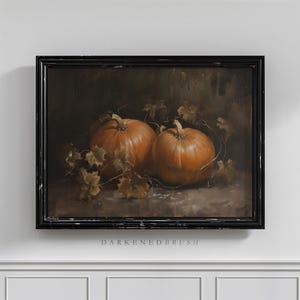 May include: A framed painting of two orange pumpkins with brown vines and leaves on a dark brown background.