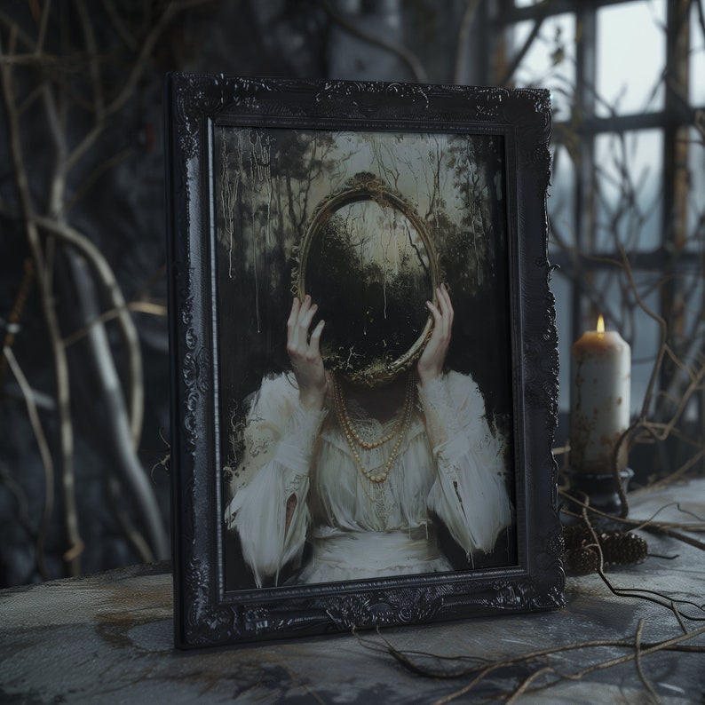May include: A framed painting of a woman with a mirror covering her face. The mirror is round and gold with a dark forest scene reflected in it. The woman is wearing a white dress with a pearl necklace. The frame is black and ornate.