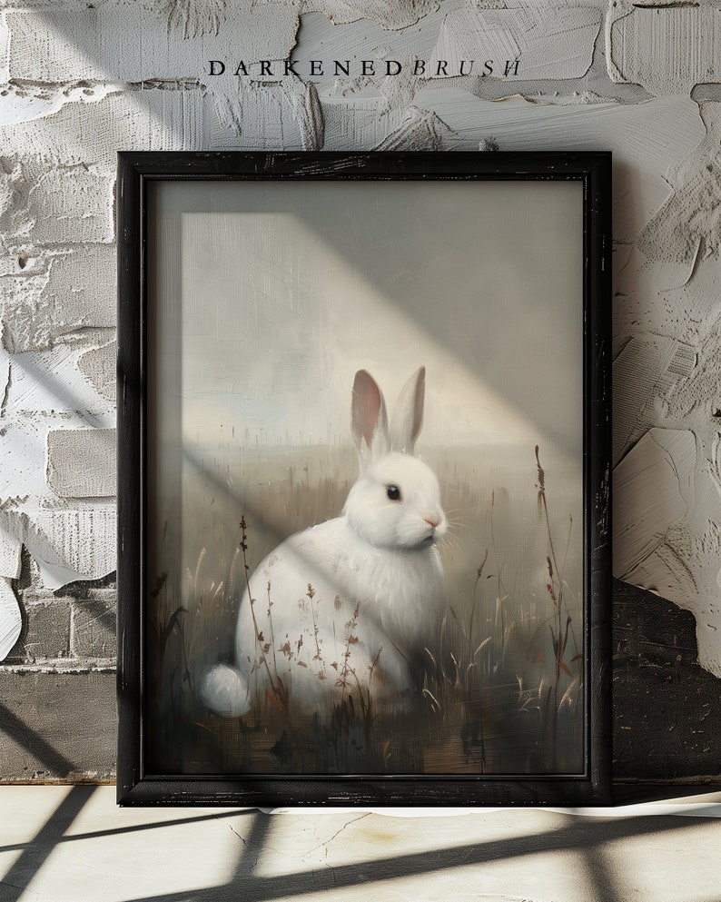 May include: A white rabbit sits in a field of tall grass. The rabbit is facing to the right and has pink ears. The background is a soft, muted brown and white.