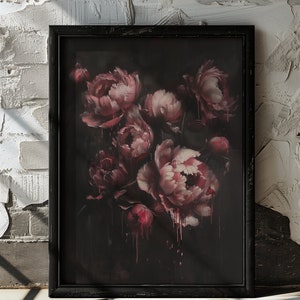 May include: A framed painting of a bouquet of pink peonies with dark red accents, painted in a dark, moody style. The painting is framed in a black frame.