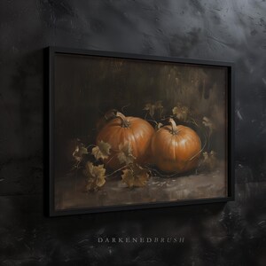 May include: Two orange pumpkins with green vines and leaves on a dark brown background.