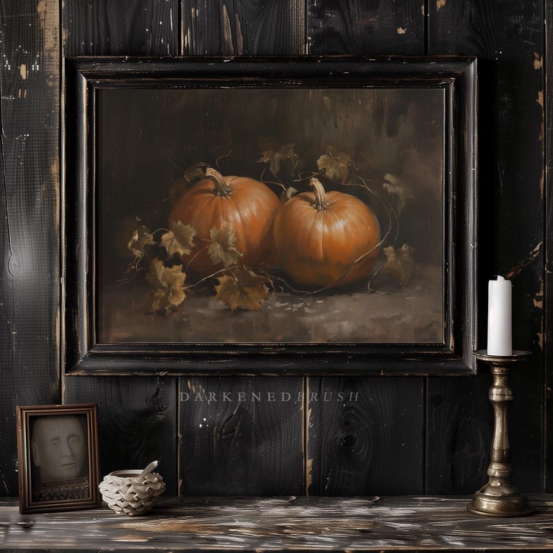 May include: A framed painting of two orange pumpkins with green leaves on a dark brown background. The frame is black and distressed.