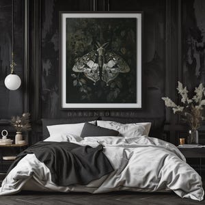 May include: A black and white moth with intricate wing patterns is depicted in a framed print, set against a dark green background. The print is hanging above a black and white bed with white bedding and a black throw blanket.