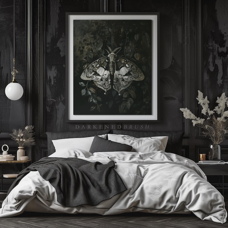 May include: A black and white moth with intricate wing patterns is depicted in a framed print, set against a dark green background. The print is hanging above a black and white bed with white bedding and a black throw blanket.