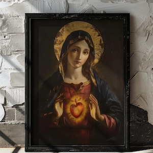 May include: A painting of the Virgin Mary with a golden halo, holding a glowing red heart in her hands. The painting is framed in a black frame.