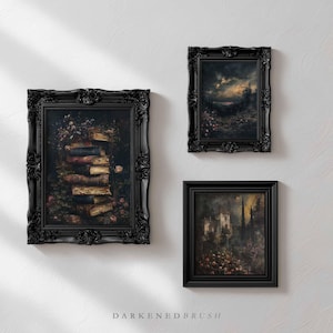 May include: Three framed art prints with ornate black frames. The artwork depicts a stack of books, a landscape with a cloudy sky, and a gothic building. The prints are mounted on a white wall.