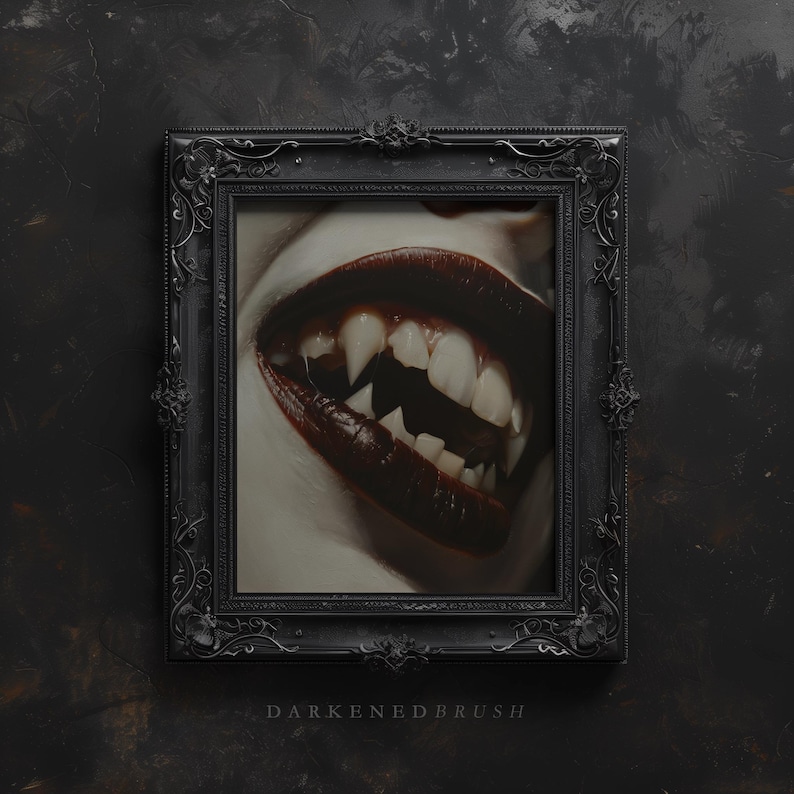 May include: A close-up of a mouth with sharp fangs and dark red lipstick. The mouth is framed in a black ornate picture frame against a dark background.