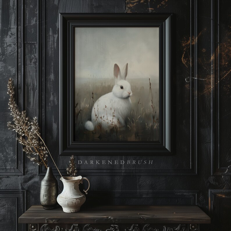 May include: A framed painting of a white rabbit sitting in a field of tall grass. The rabbit has pink eyes and a white nose. The background is a soft, muted gray.