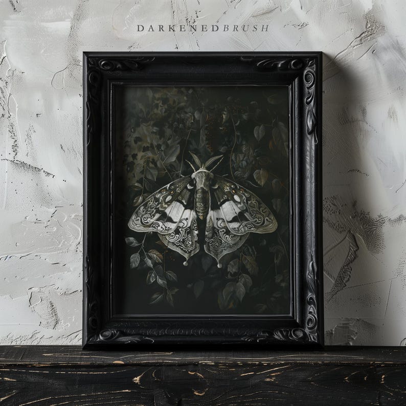 May include: A framed black and white illustration of a moth with intricate details, set against a dark green background. The frame is black with ornate detailing.