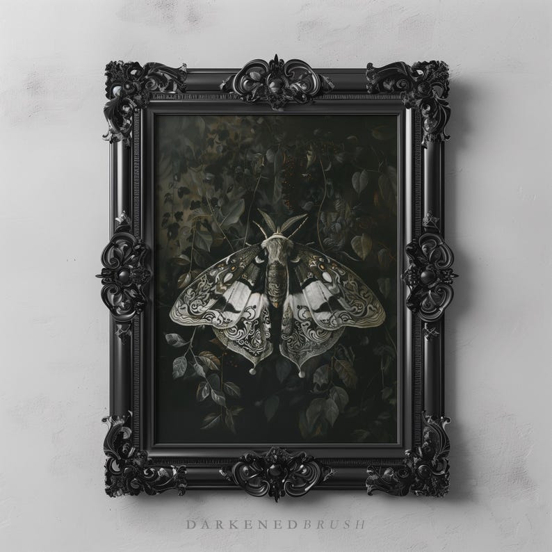 May include: A black framed print of a detailed, white and gray moth with intricate patterns on its wings. The moth is set against a dark green background with leaves and vines.