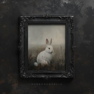 May include: A framed painting of a white rabbit sitting in a field of tall grass. The rabbit is looking to the right, and the background is a soft, hazy blue.