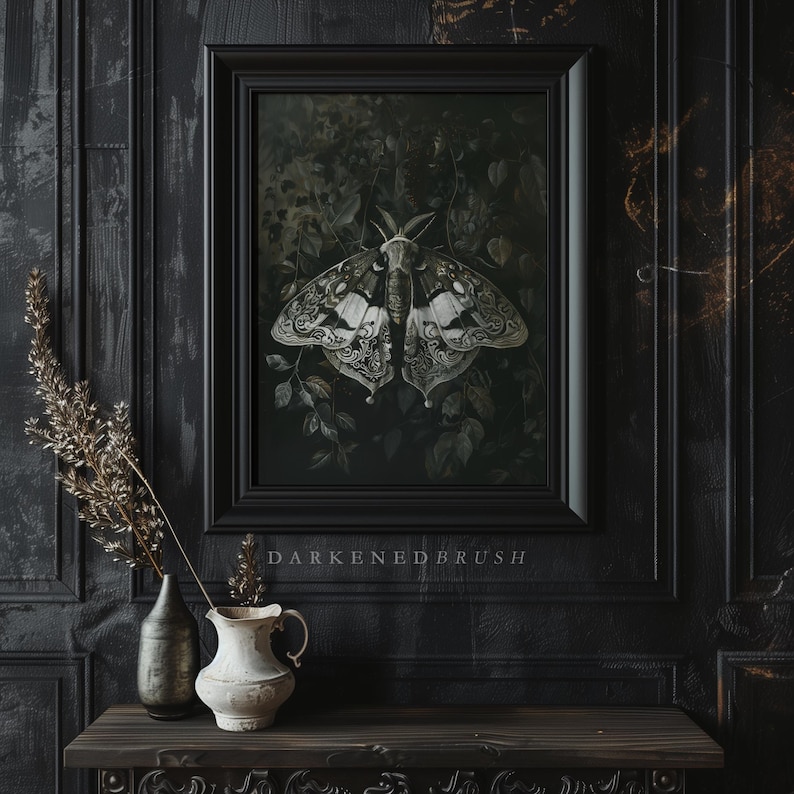 May include: A black framed print of a white and black moth with intricate details, set against a dark green background. The print is titled "Darkened Brush".