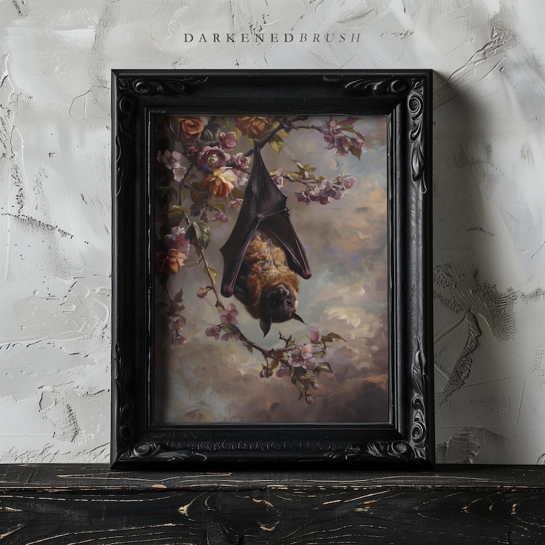 May include: A framed painting depicting a brown bat hanging upside down from a branch of a flowering tree. The bat is surrounded by pink and white blossoms. The painting is set against a cloudy sky.