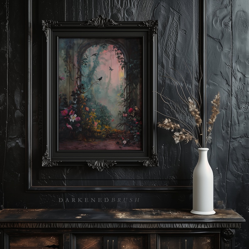 May include: A black framed picture with a painting of a lush, green garden with a stone archway and birds flying through the air. The painting is set against a dark, wood-paneled wall with a white vase and dried flowers.