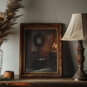 May include: A framed painting of a dark, dimly lit room with a single chair and a wreath hanging on the wall. The painting is in a dark wood frame with ornate details.