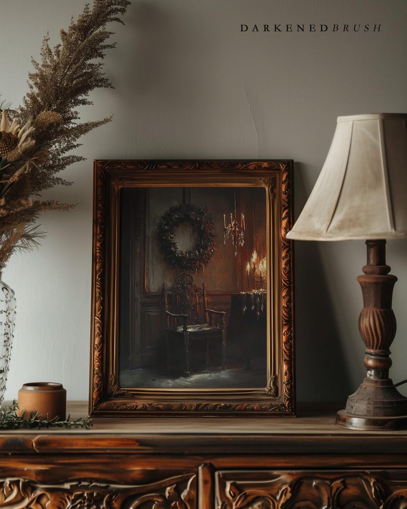 May include: A framed painting of a dark, dimly lit room with a single chair and a wreath hanging on the wall. The painting is in a dark wood frame with ornate details.