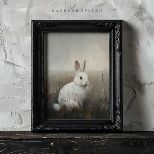 May include: A white rabbit sits in a field of tall grass. The rabbit is facing to the right and has its ears perked up. The background is a soft, blurry landscape.
