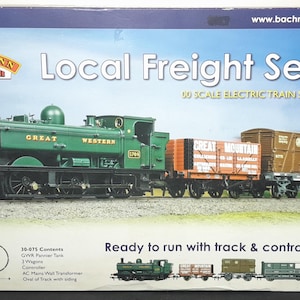 May include: A boxed 00 scale electric train set, labelled "Local Freight Set". The image shows a green steam engine with "Great Western" on the side, pulling freight cars. The set includes track and a controller. The box also includes a free DVD.