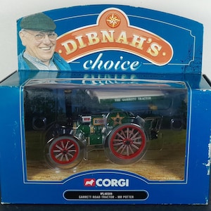 May include: A boxed Corgi model of a Garrett Road Tractor, "Mr. Potter." The tractor is green with red wheels and a star emblem. The box features the "Dibnah's Choice" logo and a portrait of a smiling man.