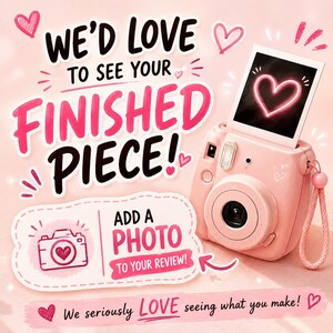 May include: A pink instant camera with a wrist strap and a photo showing a neon heart. The text reads: WE'D LOVE TO SEE YOUR FINISHED PIECE! ADD A PHOTO TO YOUR REVIEW! We seriously LOVE seeing what you make! Pink hearts and sparkles decorate the background.