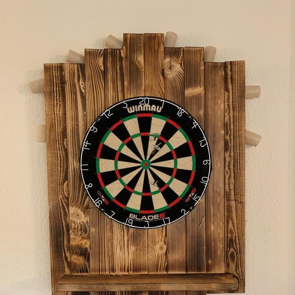 Wooden dartboard flambéed with arrow holder