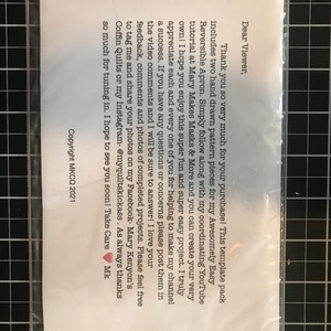 May include: A white card with a handwritten note thanking the viewer for their purchase. The note includes instructions for using the template pack to create a reversible apron. The note also mentions a YouTube tutorial and encourages viewers to share their finished projects on social media.
