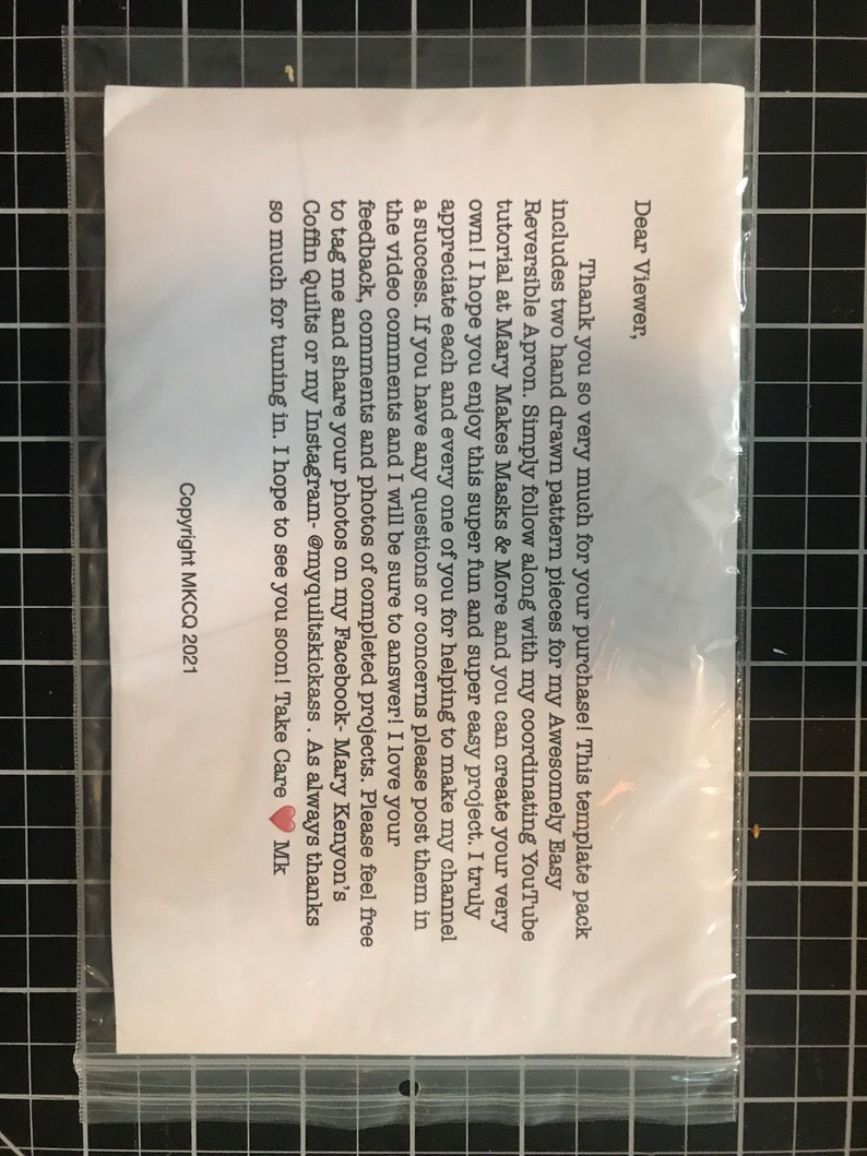 May include: A white card with a handwritten note thanking the viewer for their purchase. The note includes instructions for using the template pack to create a reversible apron. The note also mentions a YouTube tutorial and encourages viewers to share their finished projects on social media.