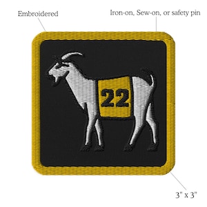 May include: Embroidered iron-on, sew-on, or safety pin patch featuring a white goat with a yellow number 22 on its side. The patch is 3 inches by 3 inches.