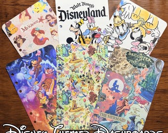 May include: A set of five rectangular planner dashboards featuring various Disney character prints, including The Little Mermaid, Mickey Mouse, and other animated figures. Each dashboard has pre-punched holes along one side for binding.