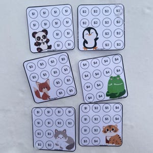 May include: Six square budget trackers with different animal illustrations. Each tracker has circles with dollar amounts. Animals include a panda, penguin, fox, frog, cat, and tiger. The trackers are white with black text and colorful animal designs.