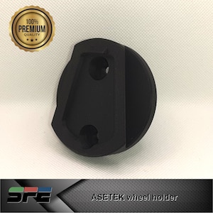 May include: A black plastic wheel holder with two holes for mounting. The holder is designed to hold a wheel securely in place.