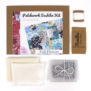 May include: A patchwork sashiko craft kit, presented in a brown cardboard box with the text "Patchwork Sashiko Kit" and "Full Flowers." The kit contains fabric, needles, thread, and a patterned fabric piece. The kit is labeled "no. 100."