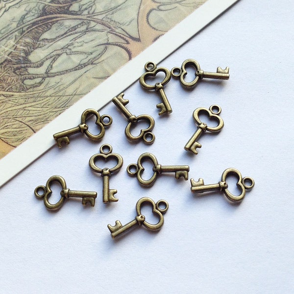 Bulk Lot 50 mini bronze KEY charms 15x9mm small antiqued brass wedding trinkets