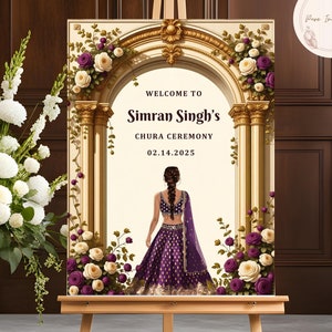 May include: Welcome to Simran Singh's Chura Ceremony on 02.14.2025. A woman in a purple and gold Indian outfit stands in front of a golden archway decorated with white and purple flowers.