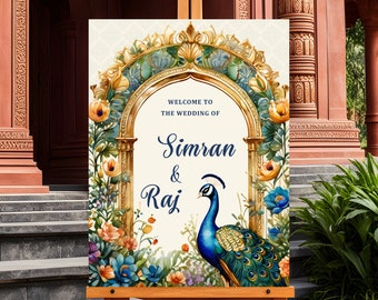 May include: A wedding welcome sign with a gold archway and floral accents. The sign reads "Welcome to the wedding of Simran & Raj" with a peacock illustration.