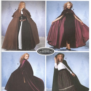 May include: Simplicity sewing pattern number 5794 for a cape. The pattern includes three different styles: a brown cape, a burgundy cape, and a green cape. The pattern is available in sizes XS, S, M, and L.