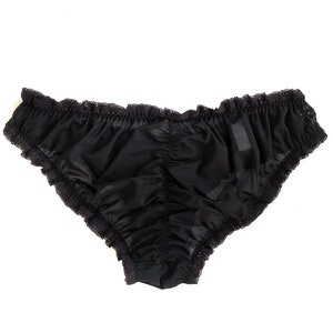 May include: Black lace trimmed underwear with a gathered, ruffled design.