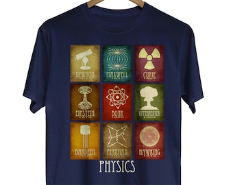 May include: A navy blue t-shirt with a graphic of nine squares featuring famous physicists and their discoveries. Each square has a different color background and a white outline. The squares are arranged in three rows of three. The text "PHYSICS" is printed in white below the squares.