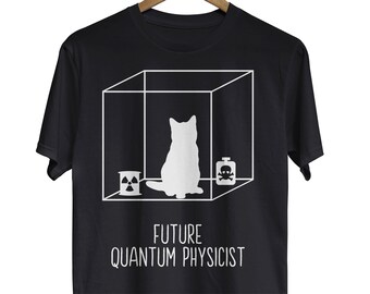 May include: Black t-shirt with a white graphic of a cat inside a box with a skull and crossbones, a can of radiation, and the text "FUTURE QUANTUM PHYSICIST".