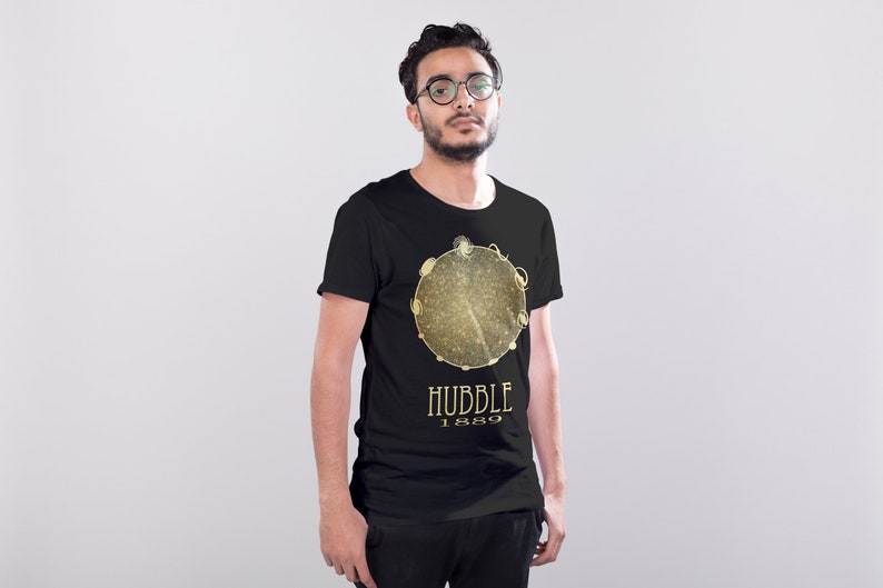 May include: A black t-shirt with a gold graphic of a galaxy with the text "HUBBLE 1889" underneath.