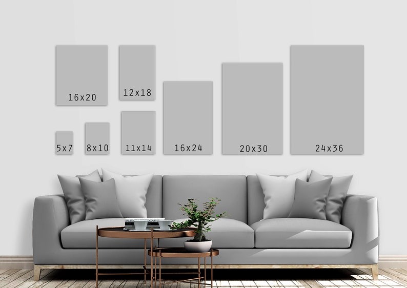 May include: A white couch with pillows in a living room setting.  There are 10 different sized frames on the wall behind the couch with the dimensions of each frame written on them.  The frames are 5x7, 8x10, 11x14, 12x18, 16x20, 16x24, 20x30, and 24x36 inches.