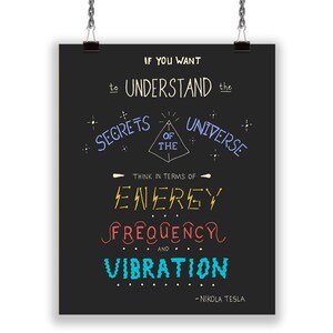 May include: A black poster with the quote "If you want to understand the secrets of the universe, think in terms of energy, frequency, and vibration" by Nikola Tesla. The text is in various colors and fonts.
